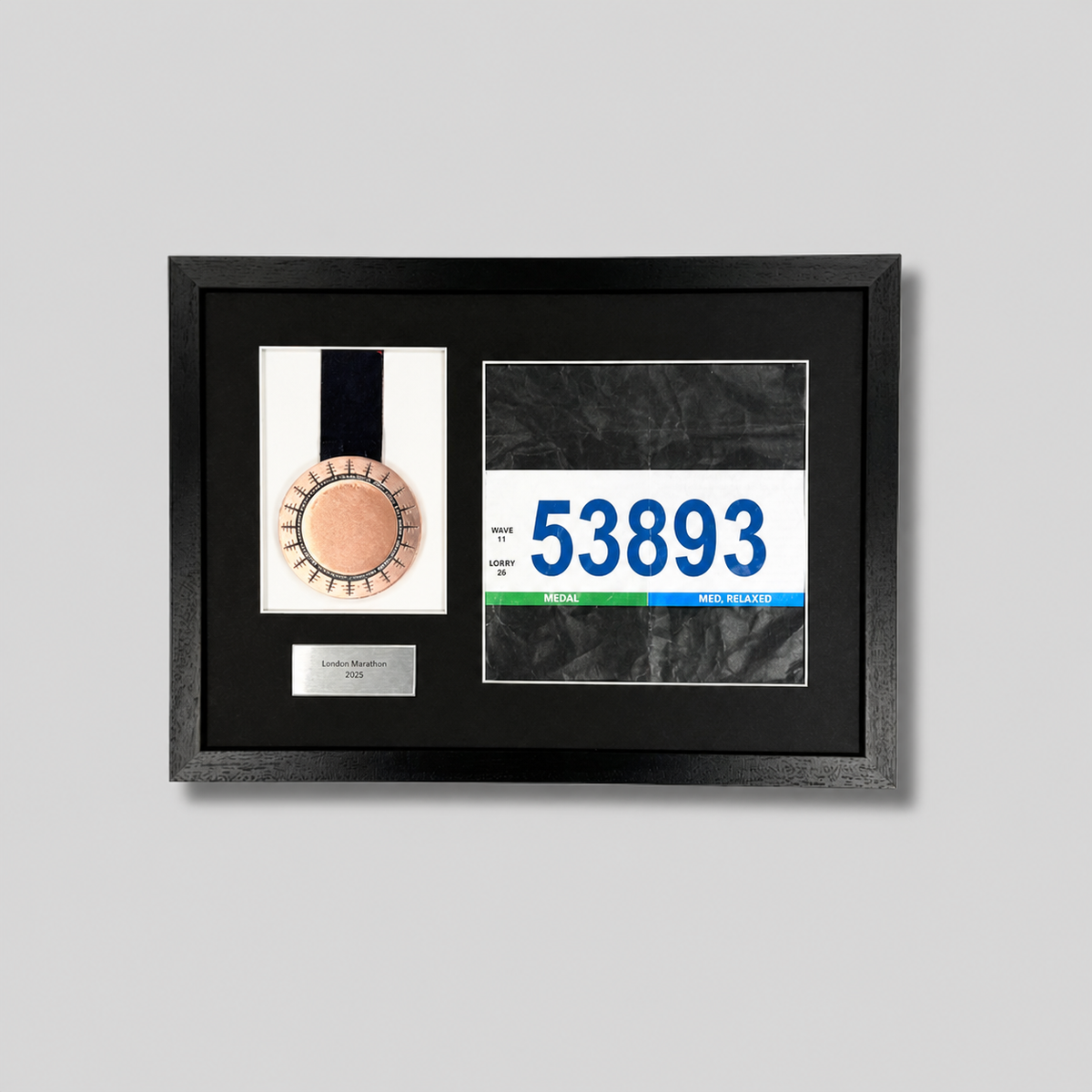 a framed display with a medal and a race number.