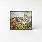 The image is a framed print depicting a cityscape with a church and other buildings in the background.