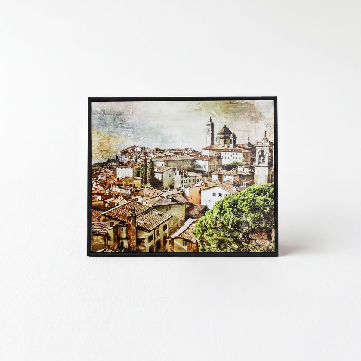 The image is a framed print depicting a cityscape with a church and other buildings in the background.