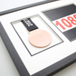 A framed medal with a black ribbon and a number "10806" displayed on the right side of the frame.